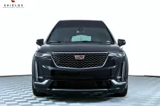 Thumbnail for Front view of a sleek black Cadillac XT6 SUV showcasing its modern design and luxury features.