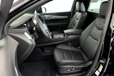 Thumbnail for Interior view of a modern black SUV showcasing leather seats and refined design features.