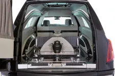 Thumbnail for Interior view of a luxury hearse showing an urn and spacious seating.
