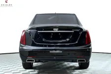 Thumbnail for Rear view of a black Cadillac Platinum showcasing its sleek design and exhaust features.