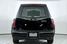 Thumbnail for Black luxury hearse with sleek design and prominent rear features in a studio setting.