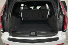 Thumbnail for Open trunk of a white SUV showing spacious cargo area with black interior and rear seats upright