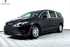 Thumbnail for Black Chrysler minivan showcased on a checkered floor with bright lighting.