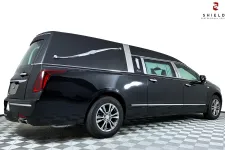 Thumbnail for Black hearse with sleek design and modern features, showcased on a patterned floor.