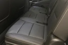 Thumbnail for Backseat of a luxury vehicle featuring black leather upholstery with white stitching and adjustable controls.