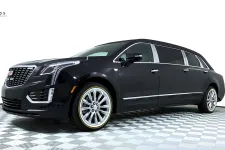 Thumbnail for Sleek black Cadillac SUV limousine with elegant design and shiny wheels on a checkered floor.