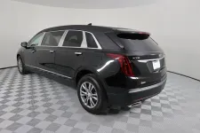 Thumbnail for Black Cadillac XT5 rear view showcasing luxury and sleek design in a studio setting.