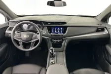 Thumbnail for Sleek interior of a modern Cadillac showcasing the dashboard, touchscreen and leather seats.