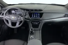 Thumbnail for Interior view of a modern Cadillac car dashboard with steering wheel, digital display, and center console controls.