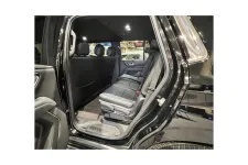 Thumbnail for Interior view of a spacious black SUV showcasing rear seating and elegant design features.