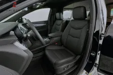 Thumbnail for Interior view of a sleek black car showcasing leather seats and modern dashboard features.