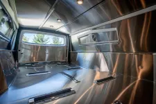 Thumbnail for Interior of a stainless steel truck bed showcasing sleek design and functional layout.
