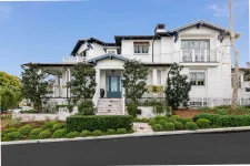Thumbnail for A large white home with a blue front door