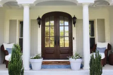 Thumbnail for a door with pillars and plants in front of it