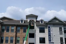 Thumbnail for a building with a green truck parked in front of it