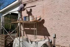 Thumbnail for a person working on a building