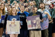 Thumbnail for a group of people holding a sign