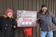 Thumbnail for a man and woman standing next to a sign