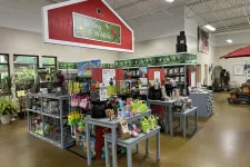 Thumbnail for Indoor garden center section with birding and wildlife supplies, bird feeders, seed bags, and gardening tools.