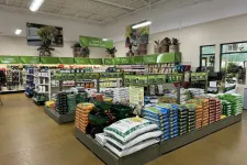 Thumbnail for Interior of a garden center with organized shelves of lawn care products, fertilizers, tools, and garden supplies.