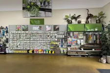 Thumbnail for Indoor garden center display with various seed packets, gardening tools, decorative plants, and accessories.