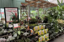 Thumbnail for Greenhouse section displaying houseplants, succulents, hanging pots, and Dr. Earth cactus potting soil bags.