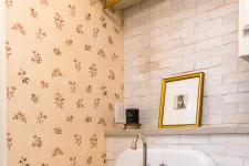 Thumbnail for Vintage white ceramic sink with chrome faucet, floral wallpaper, and white subway tile backsplash in cozy kitchen corner.