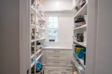Thumbnail for Bright pantry room with white shelves, storage containers, bags, and drawers under a window with natural light.