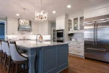 Thumbnail for Modern kitchen with marble island, white cabinetry, stainless steel appliances, and pendant lighting over bar stools