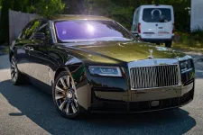 Thumbnail for Shiny black Rolls-Royce Phantom parked on a sunny street with reflections and luxury details visible
