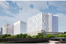 Thumbnail for Modern office buildings with reflective glass windows behind green trees under a blue sky with clouds