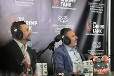 Thumbnail for Two men in suits wearing headphones speaking into microphones during The Shrimp Tank podcast at Florida Atlantic University.