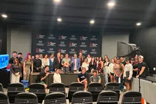Thumbnail for Group photo of diverse individuals in a studio with Shrimp Tank branding and recording equipment.
