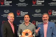 Thumbnail for Three men standing behind a table with shrimp props and podcast equipment, with The Shrimp Tank backdrop