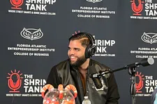 Thumbnail for Man wearing headphones speaking on a podcast with shrimp-themed decorations and Shrimp Tank banners behind him.