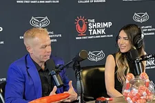 Thumbnail for Two hosts recording a podcast at The Shrimp Tank with branded backdrop and shrimp-themed props on the table
