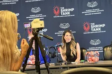 Thumbnail for Woman speaking at a Shrimp Tank event with camera and branded backdrop at Florida Atlantic Entrepreneurship Institute.