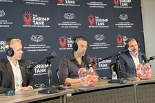 Thumbnail for Three men wearing headphones speaking into microphones at The Shrimp Tank event backdrop at Florida Atlantic University.