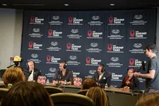 Thumbnail for Panel of speakers at The Shrimp Tank event with branded backdrop and audience in foreground