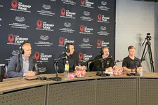Thumbnail for Four men wearing headsets sit behind microphones at a table in a podcast studio with The Shrimp Tank backdrop.