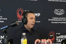 Thumbnail for Man speaking into a microphone during a podcast at Florida Atlantic Entrepreneurship Institute with shrimp tank branding.