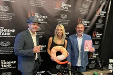 Thumbnail for Three people posing with a shrimp-shaped pillow and a book in front of The Shrimp Tank event backdrop at Florida Atlantic University.