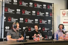 Thumbnail for a group of men sitting at a table with microphones