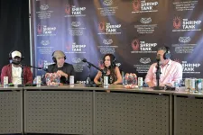 Thumbnail for Four hosts wearing headphones speak into microphones during The Shrimp Tank podcast recording with branded backdrop.