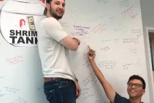 Thumbnail for a man and woman standing next to a white board with writing on it