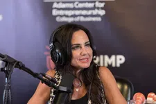 Thumbnail for Woman with headphones speaking into a microphone during a podcast at Florida Atlantic University's entrepreneurship center.