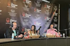 Thumbnail for a group of people sitting at a table with microphones and food