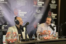 Thumbnail for Two men wearing headphones discussing on a podcast set with shrimp and Celsius drink cans on the table