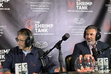 Thumbnail for Two men with headphones sitting at a podcast table with microphones and Celsius energy drinks during The Shrimp Tank event.