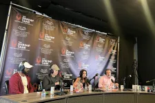 Thumbnail for Panel of four hosts and guests with microphones at The Shrimp Tank event table with branded backdrop